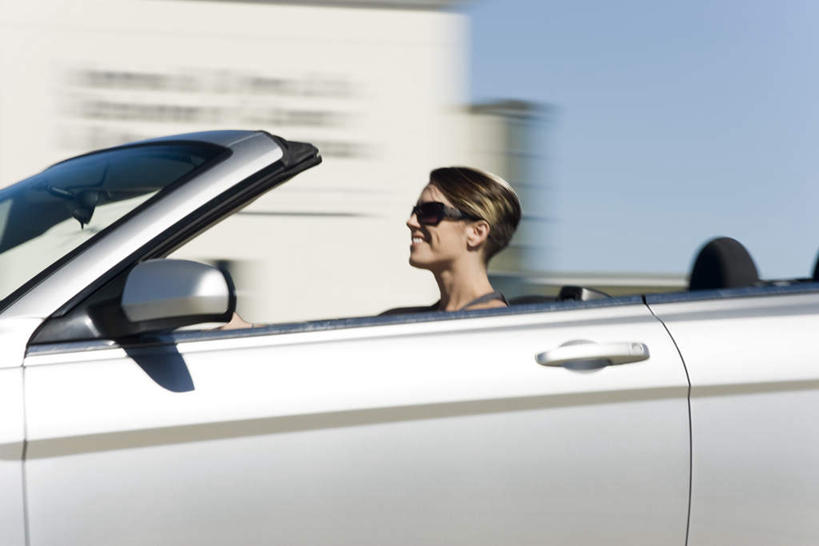 西方人,一个人,坐,笑,微笑,露齿笑,横图,室外,白天,侧面,汽车,欧洲,欧洲人,仅一个年轻女性,仅一个女性,仅一个人,一辆,握,墨镜,眼镜,拿,拿着,车,蓝色,蓝天,天空,太阳镜,太阳眼镜,交通工具,轿车,天,驾驶,行驶,遮阳镜,握着,晴朗,控制,万里无云,年轻女性,女人,女性,白种人,晴空,晴空万里,坐着,半身,彩图