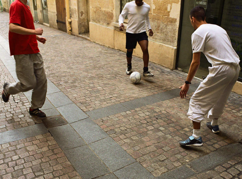 西方人,三个人,伙伴,朋友,家,横图,俯视,室外,白天,锻炼,友谊,运动,足球,道路,路,欧洲,非洲,黑人,欧洲人,阴影,光线,下水道,影子,房屋,屋子,小路,足球装备,交通,运动器械,楼房,住宅,阳光,健身器械,室外运动,健身器材,户外运动,蹴鞠,友情,足球运动,男人,男性,年轻男性,白种人,非洲人,彩图,高角度拍摄,全身,健身,房子,运动器材