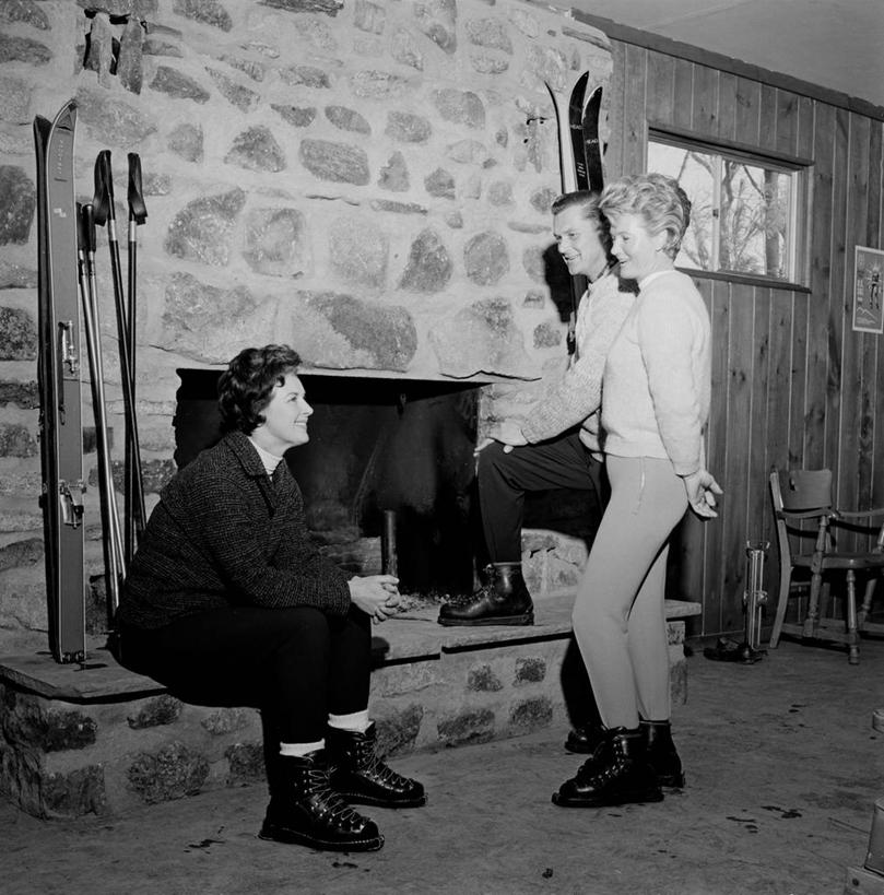 西方人,成年人,中年人,三个人,站,坐,微笑,竖图,方图,黑白,室内,白天,侧面,度假,友谊,壁炉,欧洲,纽约,美国,欧洲人,放松,摄影,滑雪杖,冬季运动,滑雪运动,中年男性,中年女性,白种人,休闲活动,说话